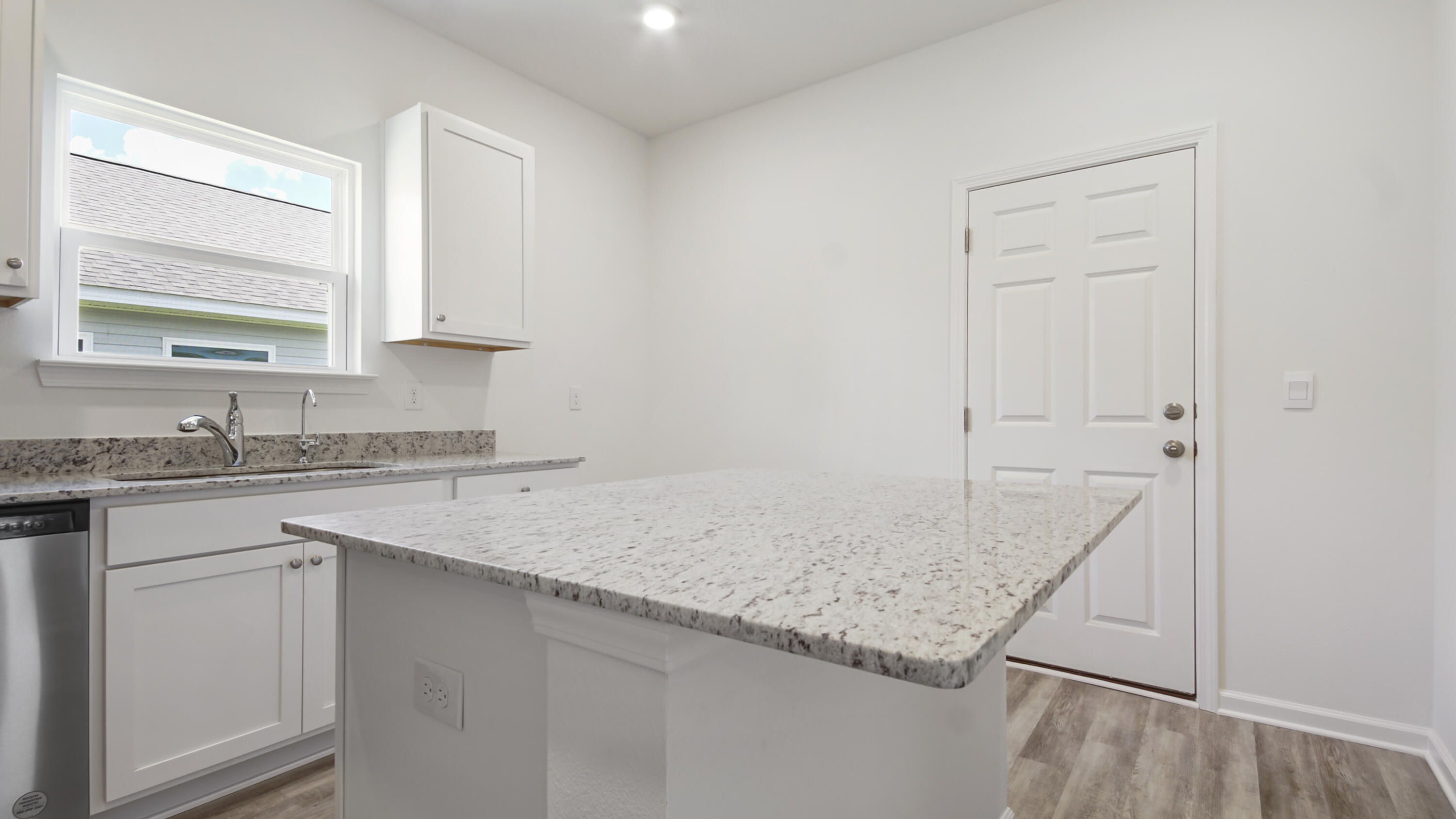 494 Arrowwood Boulevard Freeport, FL 32439 - Photo 9 of 32 a kitchen with a sink stove and cabinets