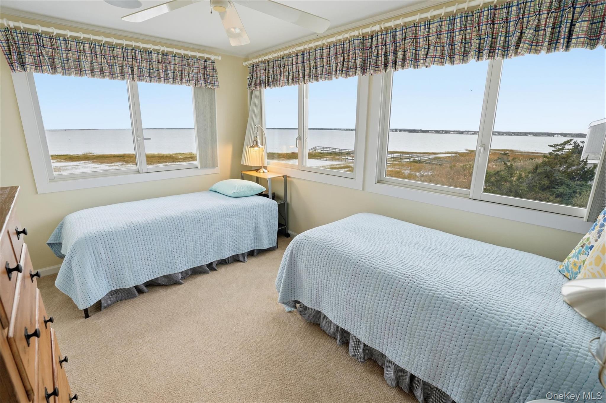 556 Dune Road Westhampton, NY 11978 - Photo 16 of 20 a bedroom with two beds and a large window