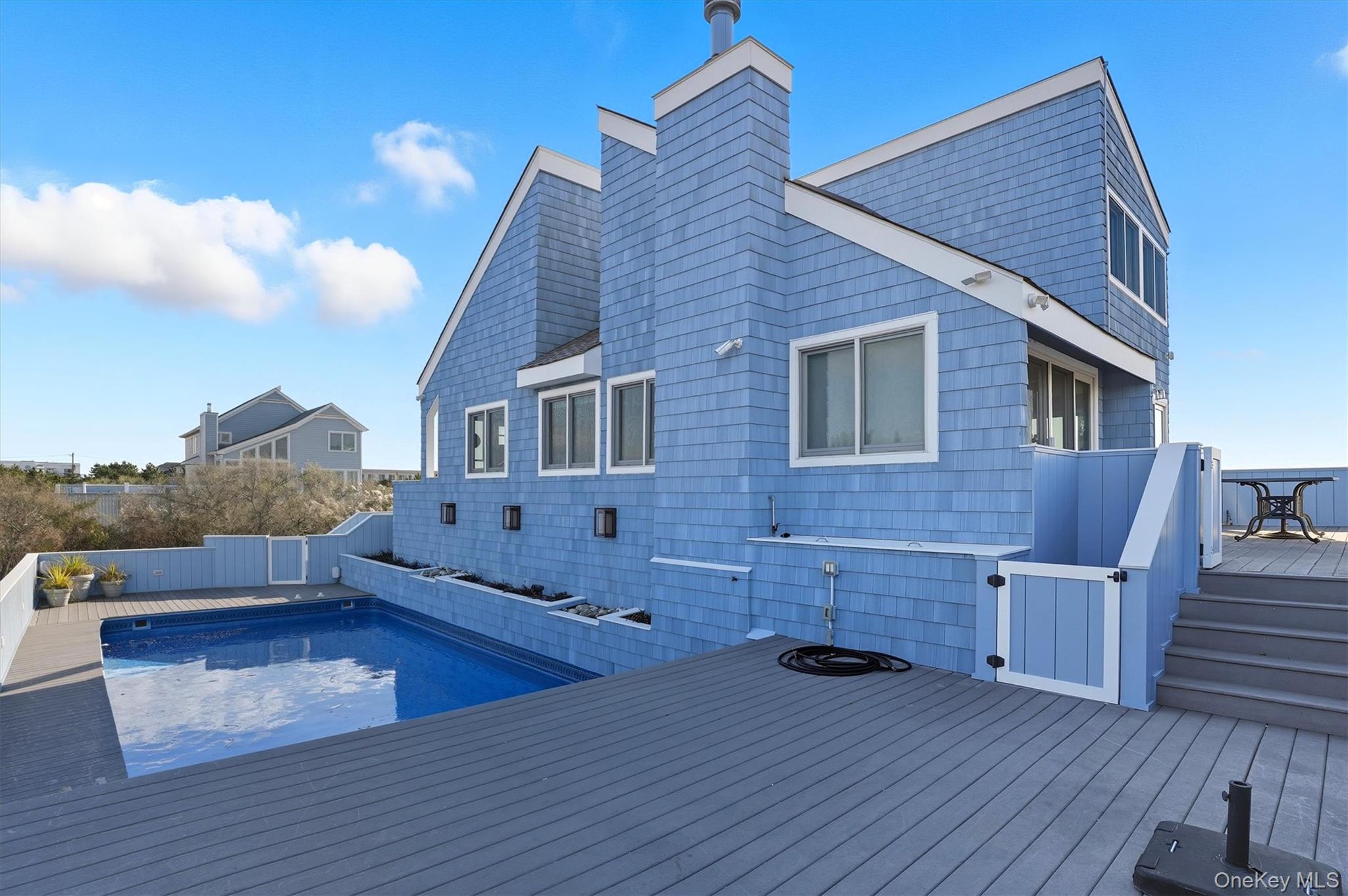 556 Dune Road Westhampton, NY 11978 - Photo 18 of 20 a view of a house with pool and wooden floor