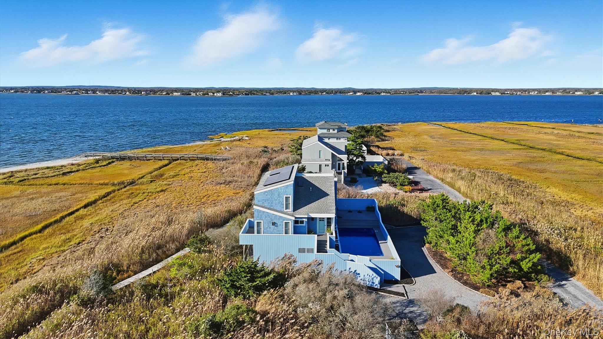 556 Dune Road Westhampton, NY 11978 - Photo 19 of 20 a view of an ocean with a mountain