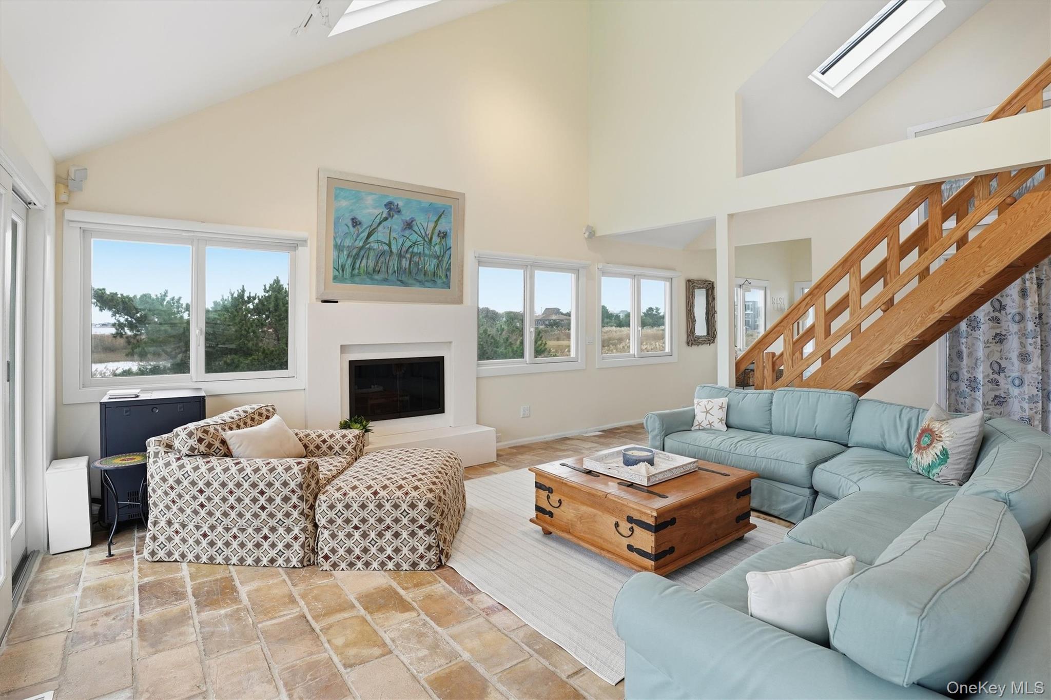 556 Dune Road Westhampton, NY 11978 - Photo 4 of 20 a living room with furniture fireplace and a large window