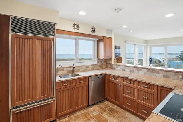 a kitchen with a sink window and cabinets