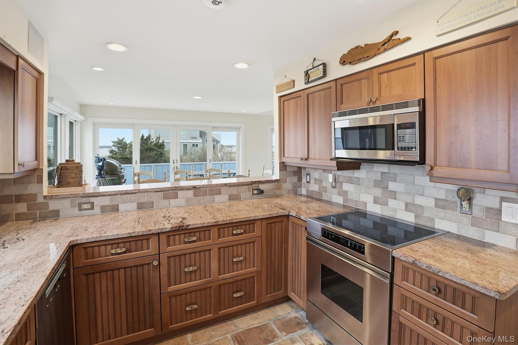 556 Dune Road Westhampton, NY 11978 - Photo 7 of 20 a kitchen with stainless steel appliances granite countertop a sink stove and microwave