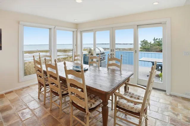 a dining room with furniture a chandelier and wooden floor