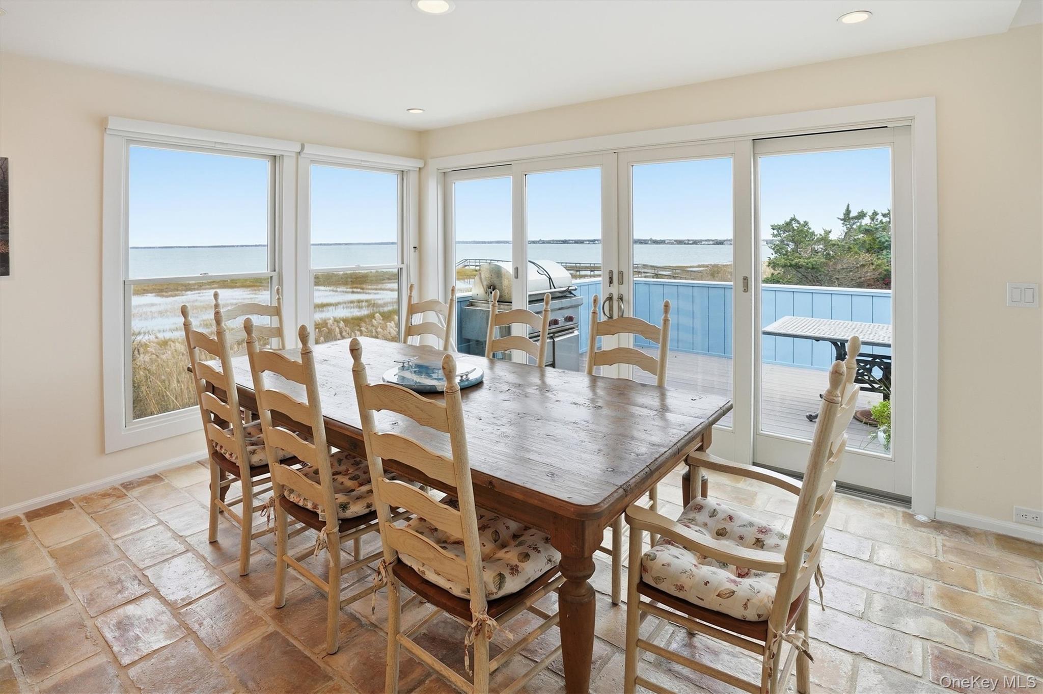 556 Dune Road Westhampton, NY 11978 - Photo 9 of 20 a dining room with furniture a chandelier and wooden floor