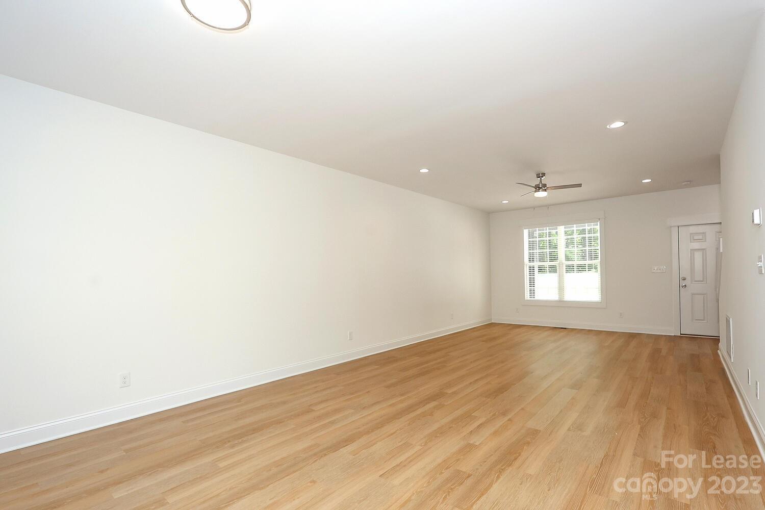 8710 Island Point Road Sherrills Ford, NC 28673 - Photo 11 of 48 an empty room with wooden floor and windows