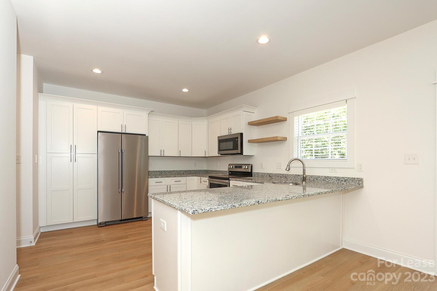 8710 Island Point Road Sherrills Ford, NC 28673 - Photo 17 of 48 a kitchen with stainless steel appliances granite countertop a sink a refrigerator and a granite counter tops