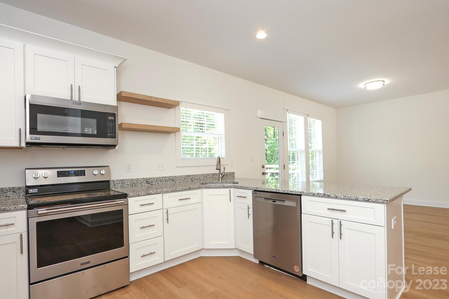8710 Island Point Road Sherrills Ford, NC 28673 - Photo 20 of 48 a kitchen with white cabinets appliances and a sink
