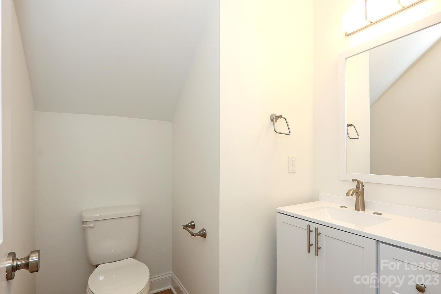 8710 Island Point Road Sherrills Ford, NC 28673 - Photo 23 of 48 a bathroom with a toilet sink and mirror