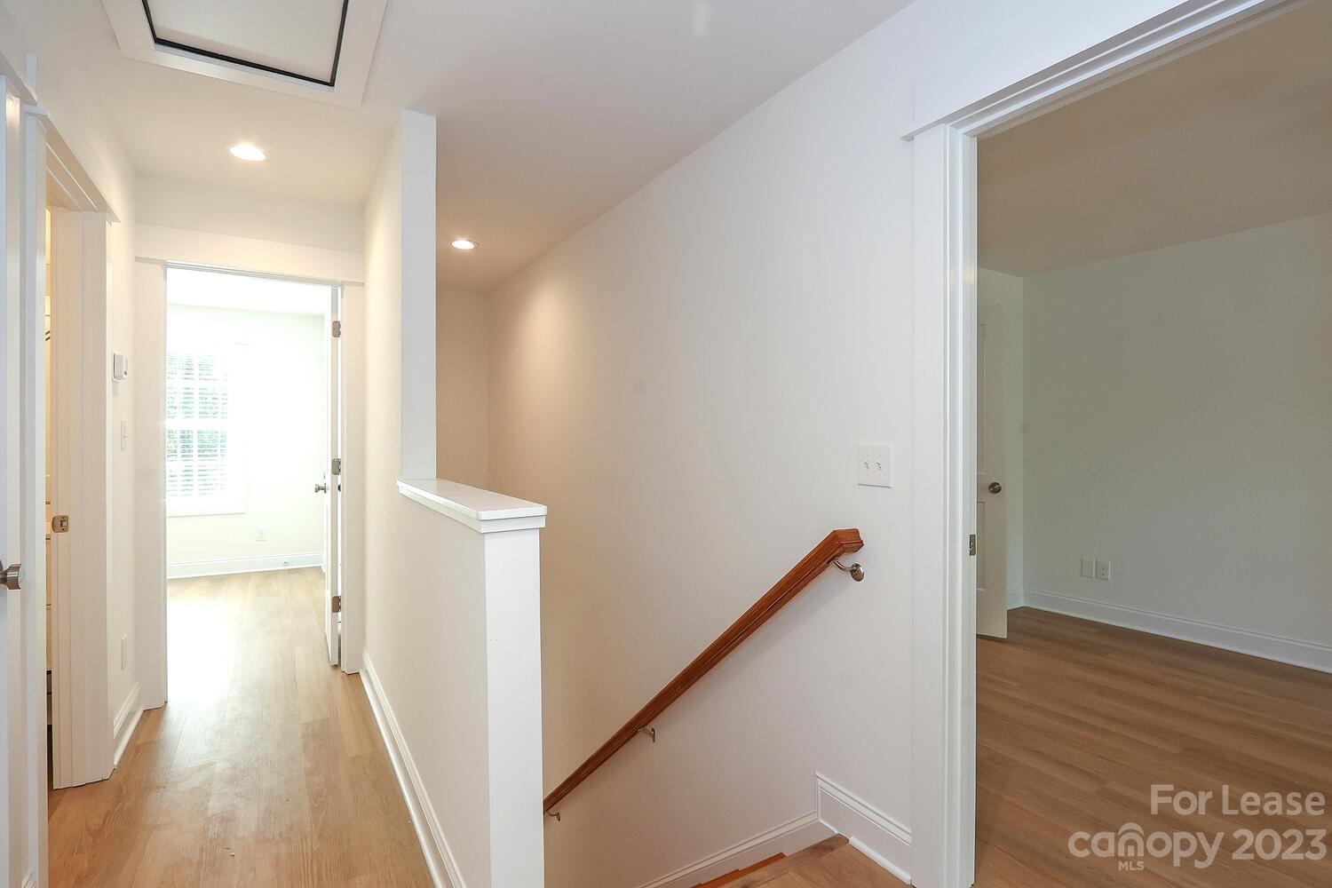 8710 Island Point Road Sherrills Ford, NC 28673 - Photo 25 of 48 a view of a hallway with wooden floor and staircase
