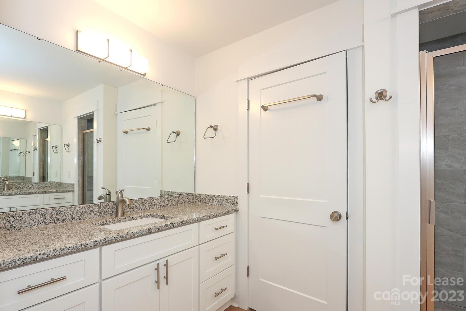 8710 Island Point Road Sherrills Ford, NC 28673 - Photo 34 of 48 a bathroom with a granite countertop sink and a mirror