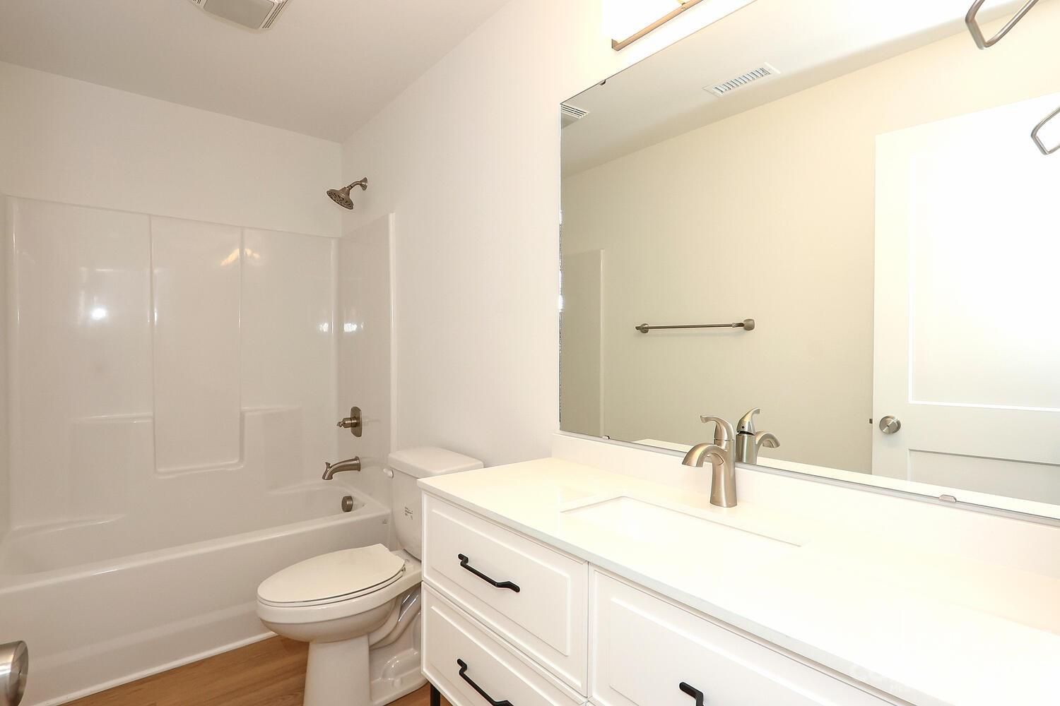 8710 Island Point Road Sherrills Ford, NC 28673 - Photo 40 of 48 a bathroom with a sink a toilet a mirror a bathtub and shower