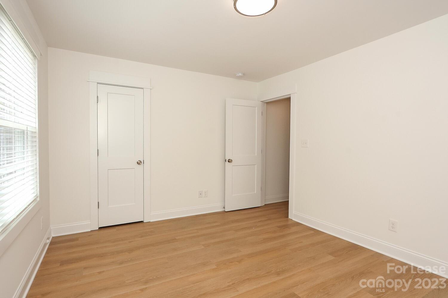 8710 Island Point Road Sherrills Ford, NC 28673 - Photo 43 of 48 a view of an empty room with wooden floor and a window