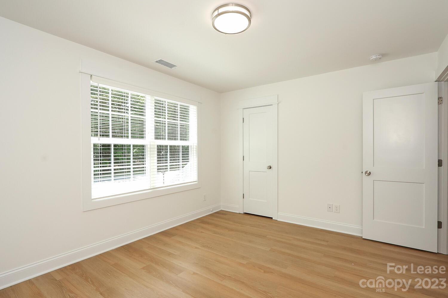 8710 Island Point Road Sherrills Ford, NC 28673 - Photo 44 of 48 an empty room with wooden floor and windows