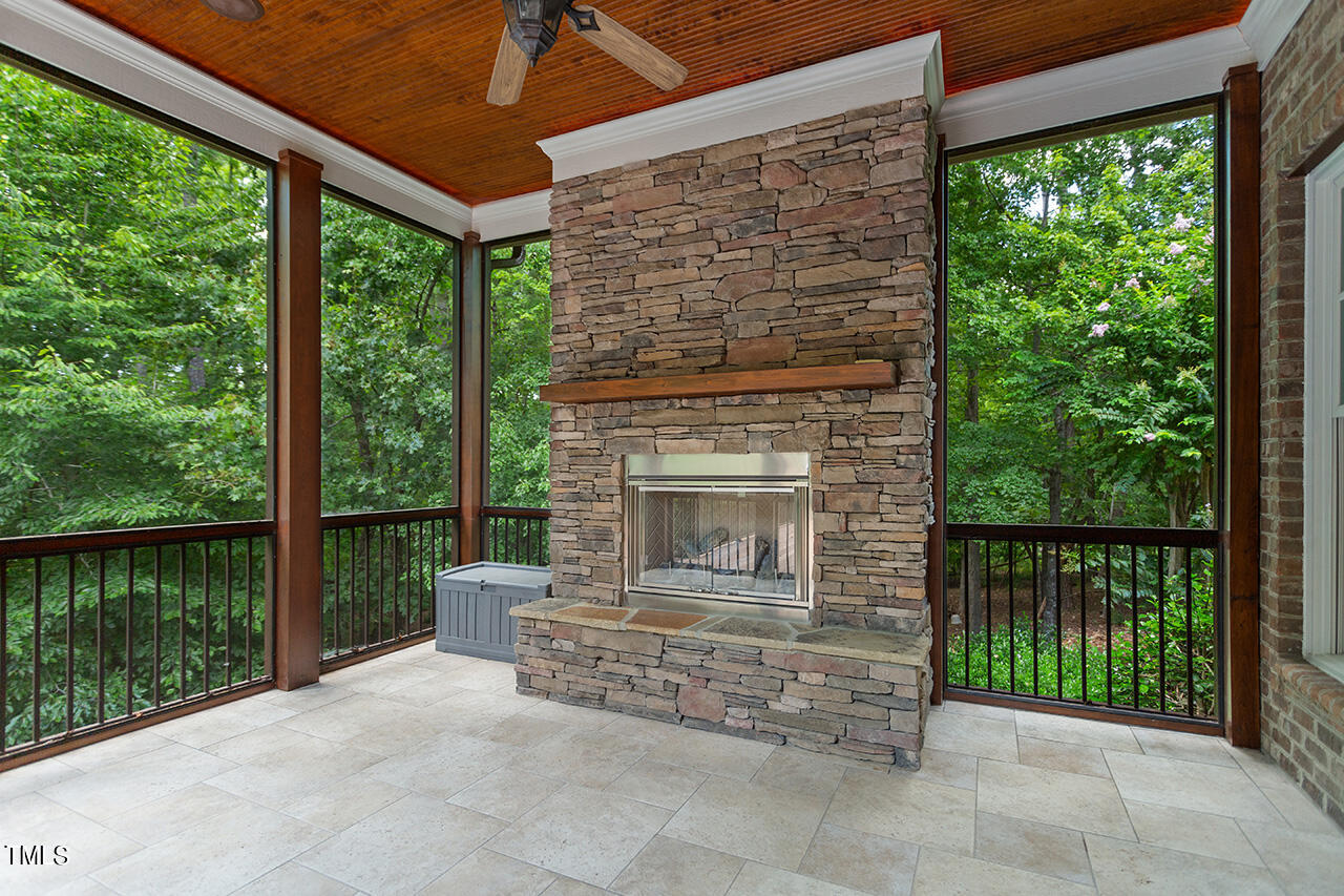 11321 Royal Amber Way Raleigh, NC 27614 - Photo 37 of 46 Off of the kitchen is the tiled screened porch with gas fireplace