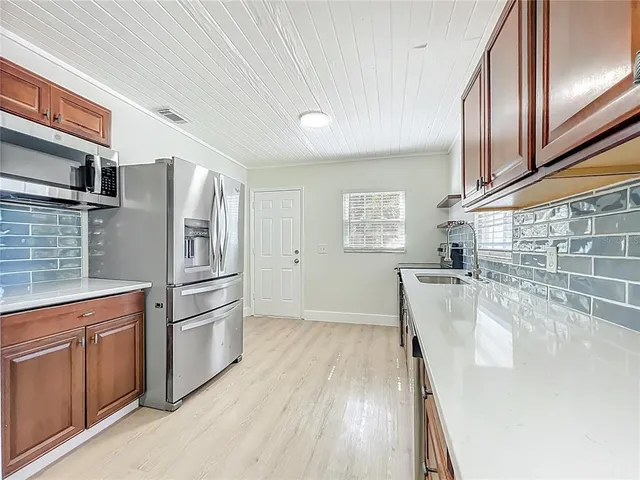 a kitchen with granite countertop a refrigerator and a stove