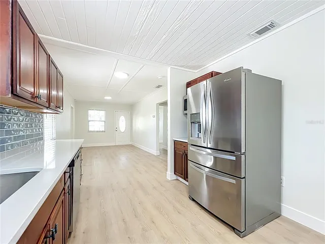 a kitchen with stainless steel appliances granite countertop a refrigerator and a sink