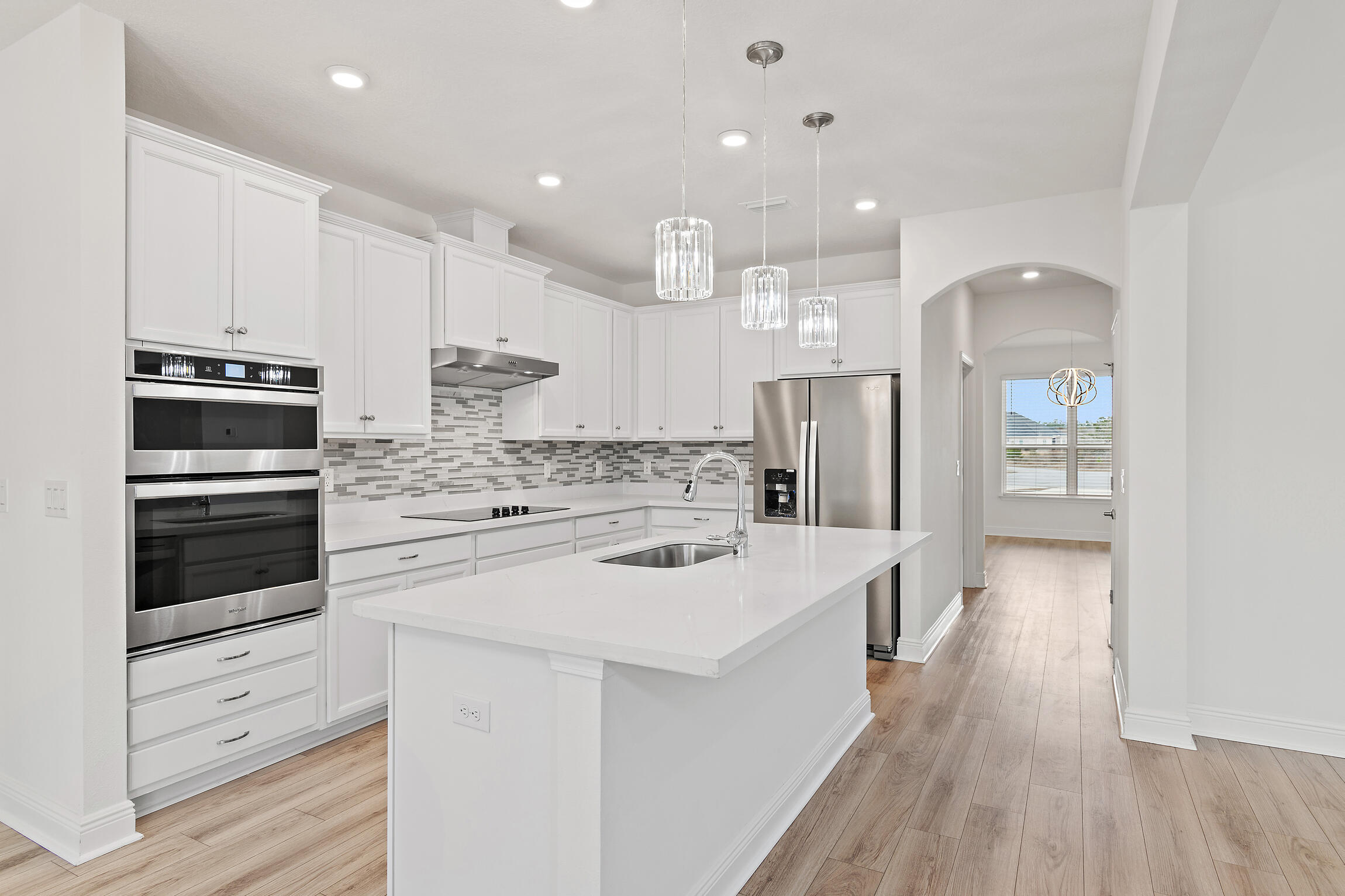 430 Fairway Crossing Freeport, FL 32439 - Photo 11 of 57 a kitchen with stainless steel appliances kitchen island granite countertop a stove a sink and a refrigerator