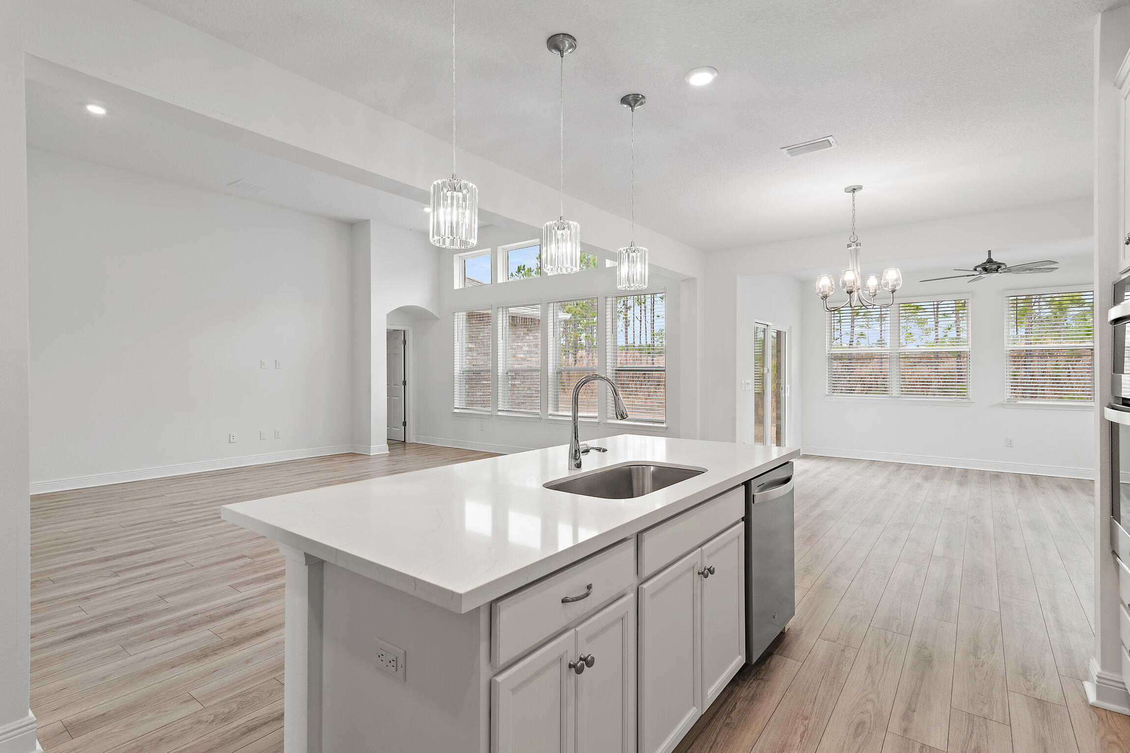 430 Fairway Crossing Freeport, FL 32439 - Photo 12 of 57 a kitchen with center island wooden floor and a chandelier