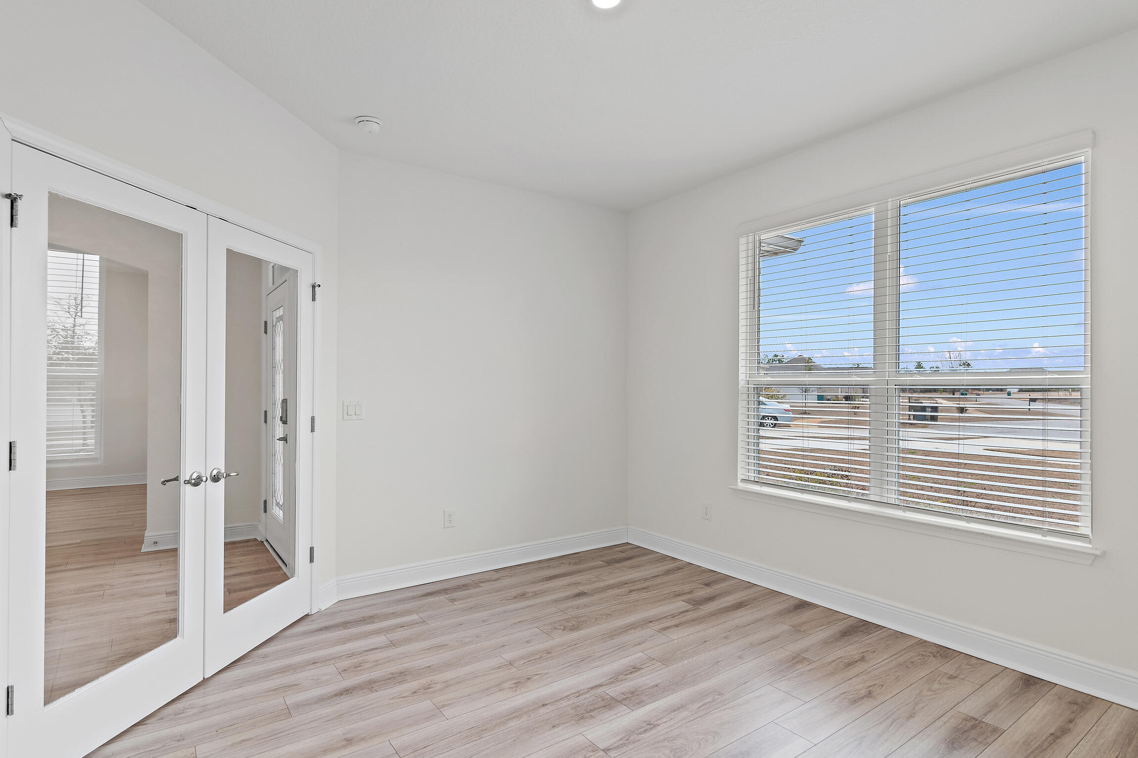 430 Fairway Crossing Freeport, FL 32439 - Photo 23 of 57 a view of an empty room with wooden floor and a window