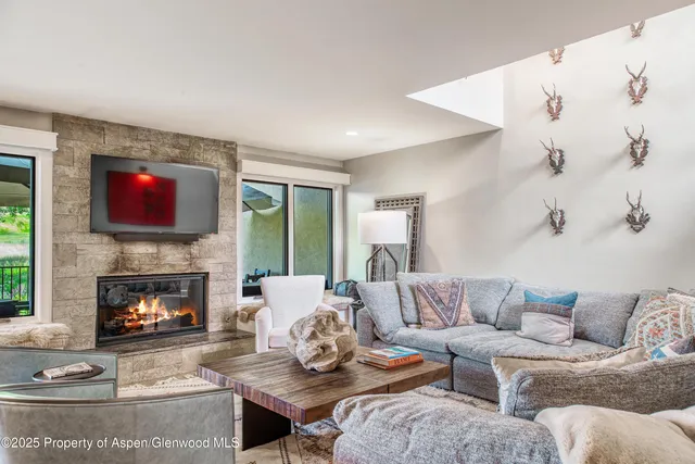 a living room with furniture fireplace and window