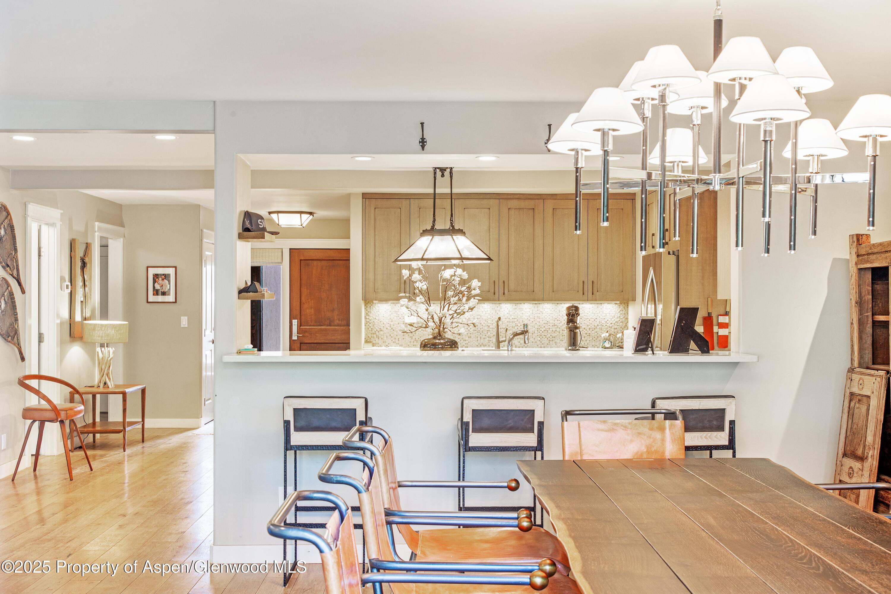 52 Harleston Green, Unit 38 Snowmass Village, CO 81615 - Photo 14 of 40 a room with chandelier fan and wooden floor