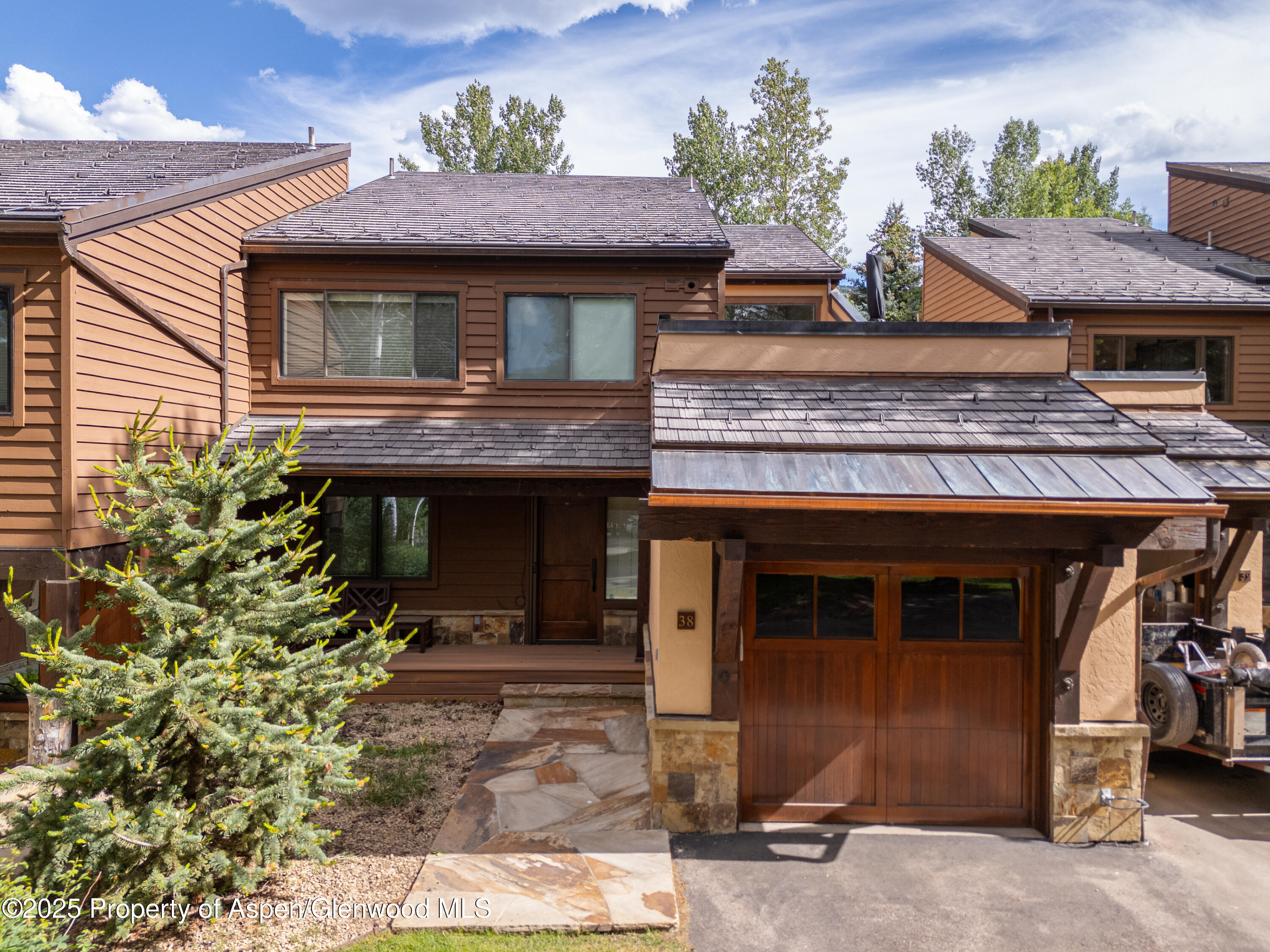 52 Harleston Green, Unit 38 Snowmass Village, CO 81615 - Photo 15 of 40 a front view of a house with yard