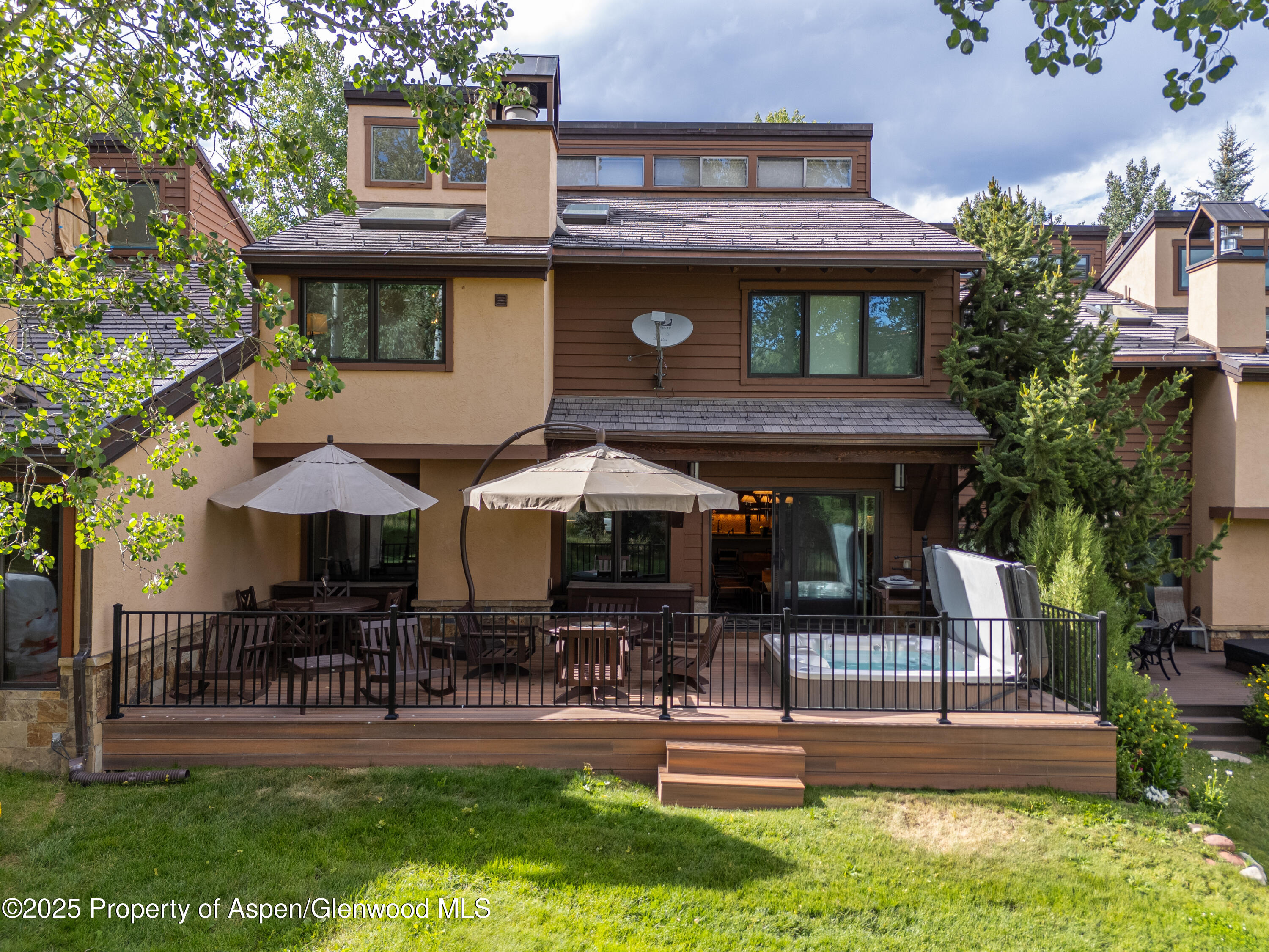 52 Harleston Green, Unit 38 Snowmass Village, CO 81615 - Photo 21 of 40 a front view of a house with garden and patio