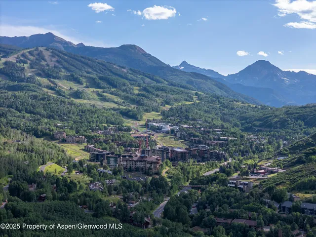 an aerial view of residential house and sandy dunes