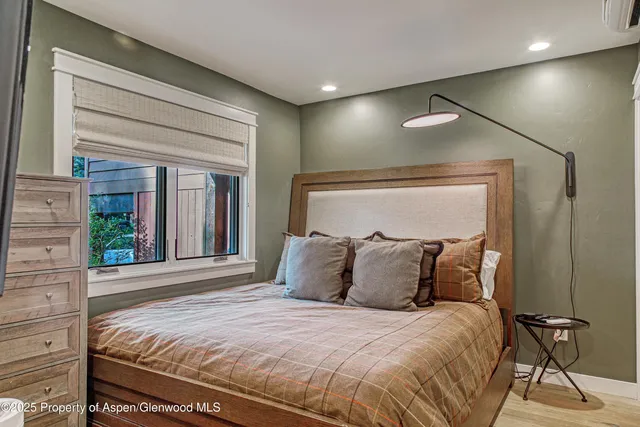 a bedroom with a bed and glass windows