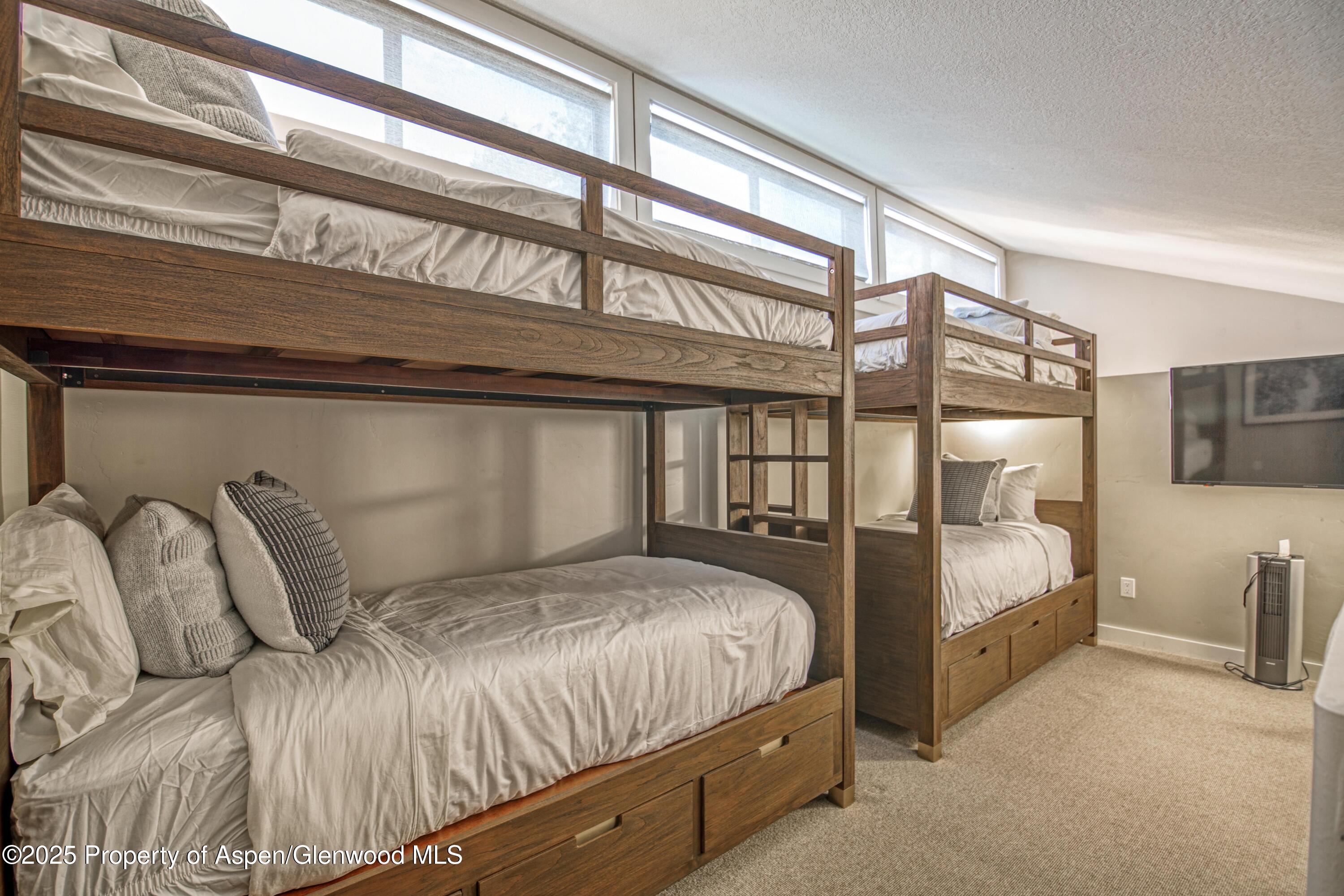 52 Harleston Green, Unit 38 Snowmass Village, CO 81615 - Photo 33 of 40 a bedroom with a bed and large window