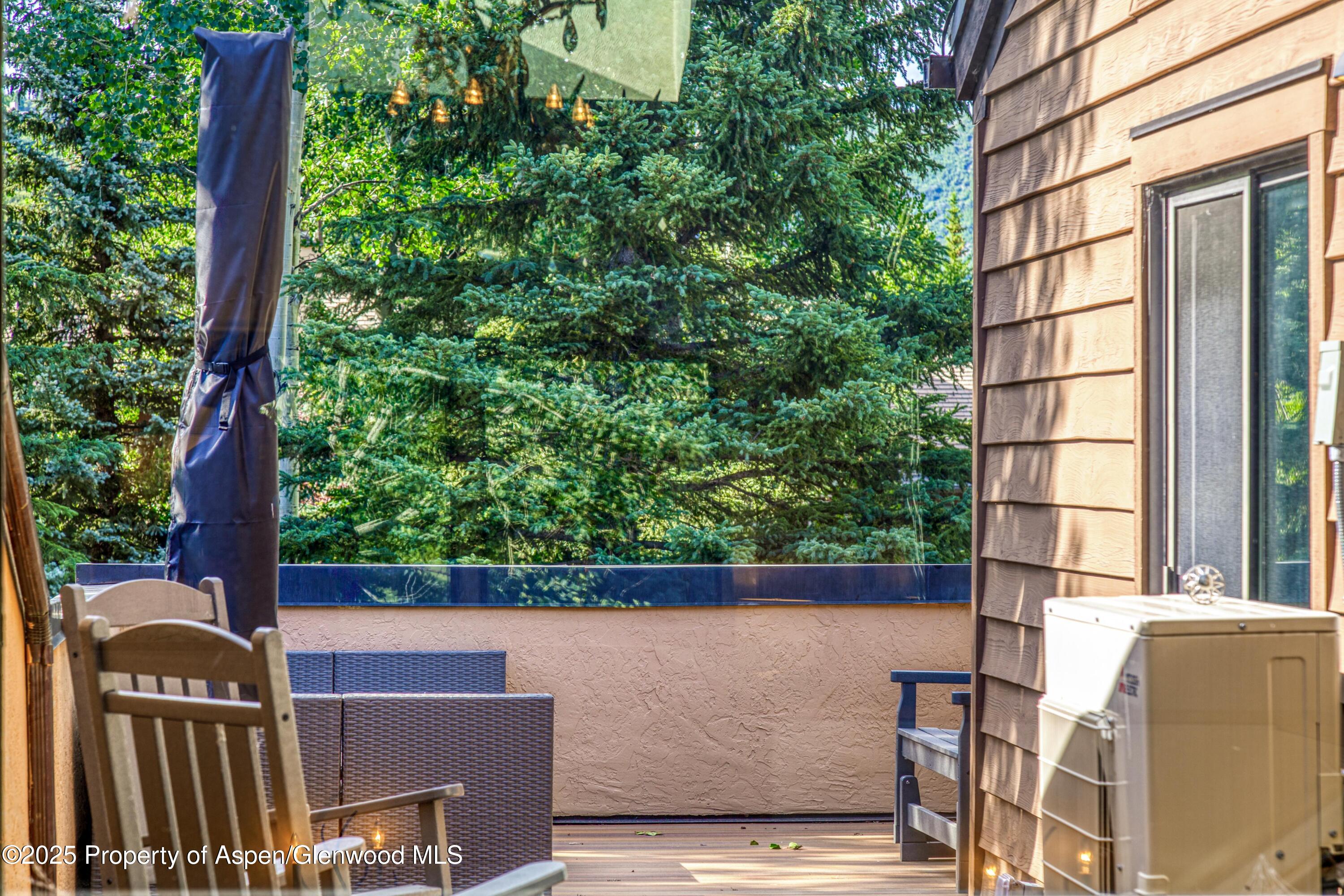 52 Harleston Green, Unit 38 Snowmass Village, CO 81615 - Photo 35 of 40 a view of a brick wall with a tree in front of it