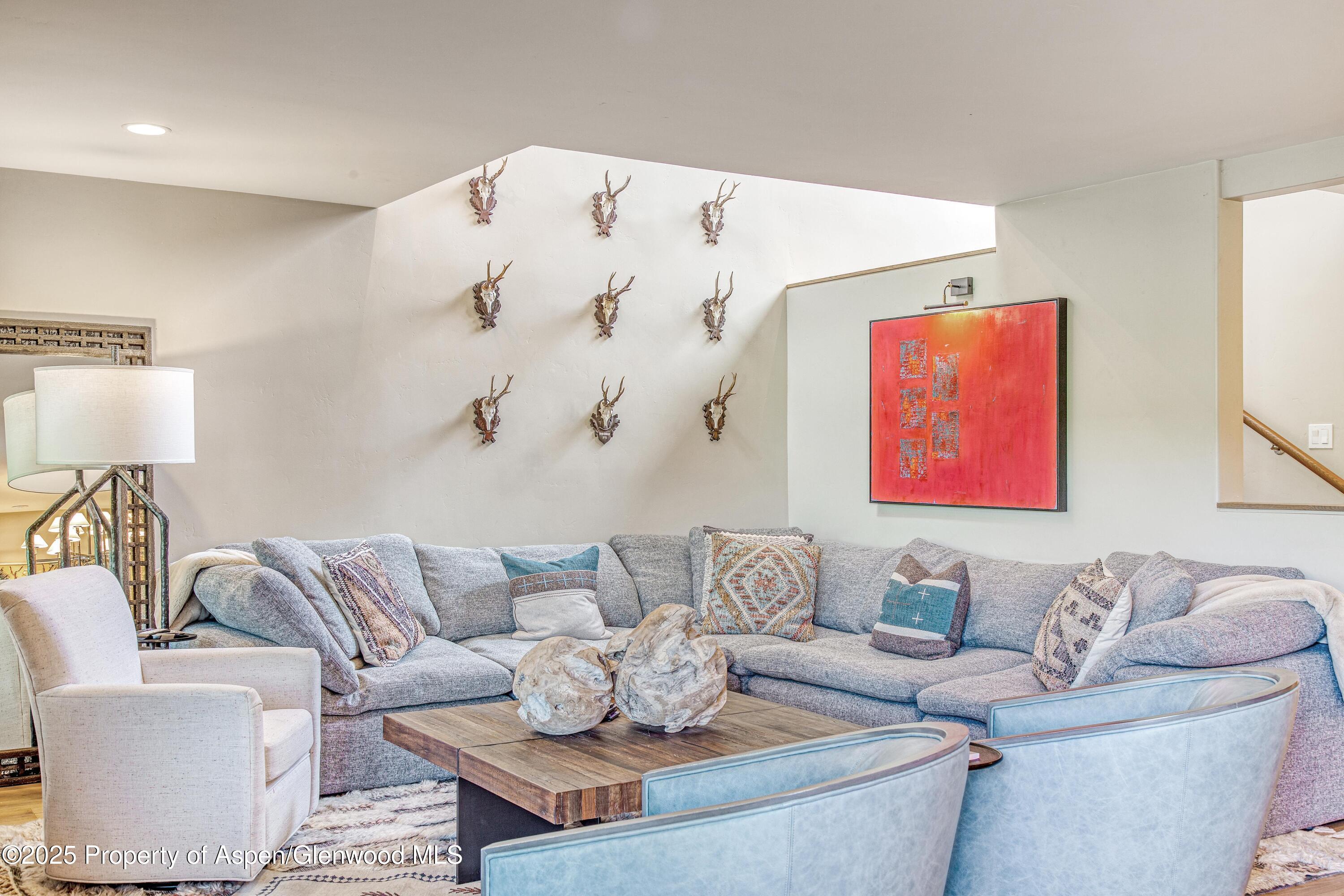 52 Harleston Green, Unit 38 Snowmass Village, CO 81615 - Photo 4 of 40 a living room with furniture and a couch