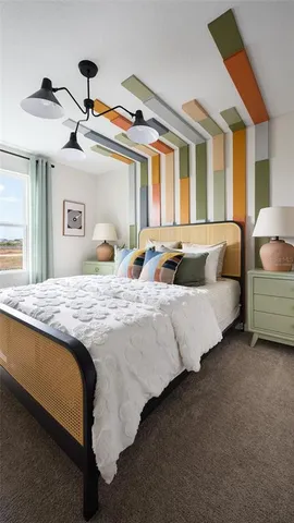 a spacious bedroom with a bed and a chandelier