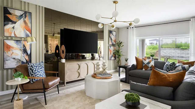 a living room with furniture a flat screen tv and a large window