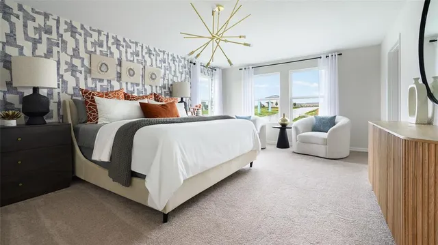 a spacious bedroom with bed and a chandelier