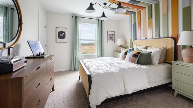 a bedroom with a bed dresser and a window