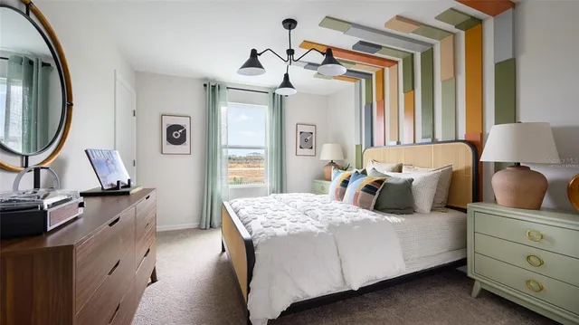 a bedroom with a bed and a flat tv screen on the dresser