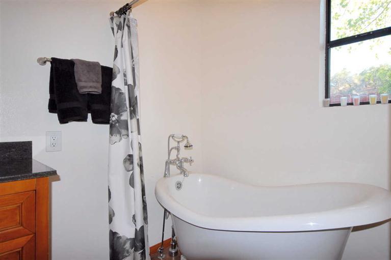 198 Riverside Road Oak View, CA 93022 - Photo 16 of 24 a bathroom with a bathtub and a window