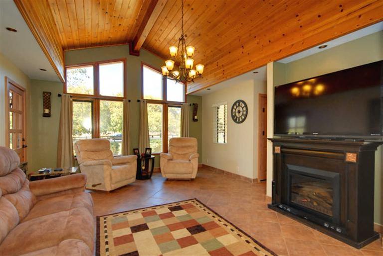 198 Riverside Road Oak View, CA 93022 - Photo 3 of 24 a living room with furniture a flat screen tv and a fireplace