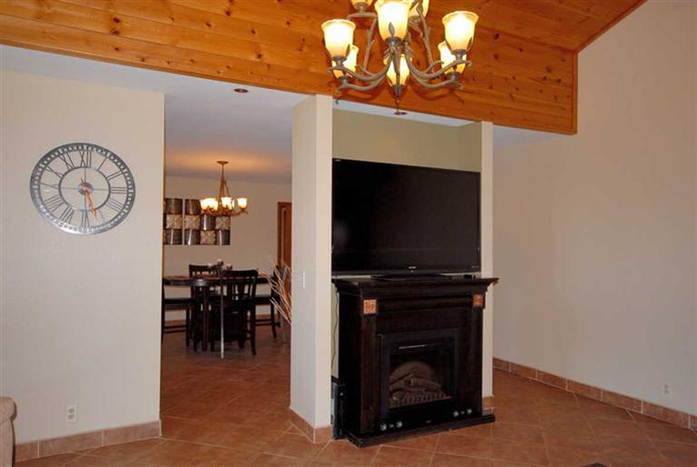 198 Riverside Road Oak View, CA 93022 - Photo 5 of 24 a living room with furniture a dining table and a fireplace