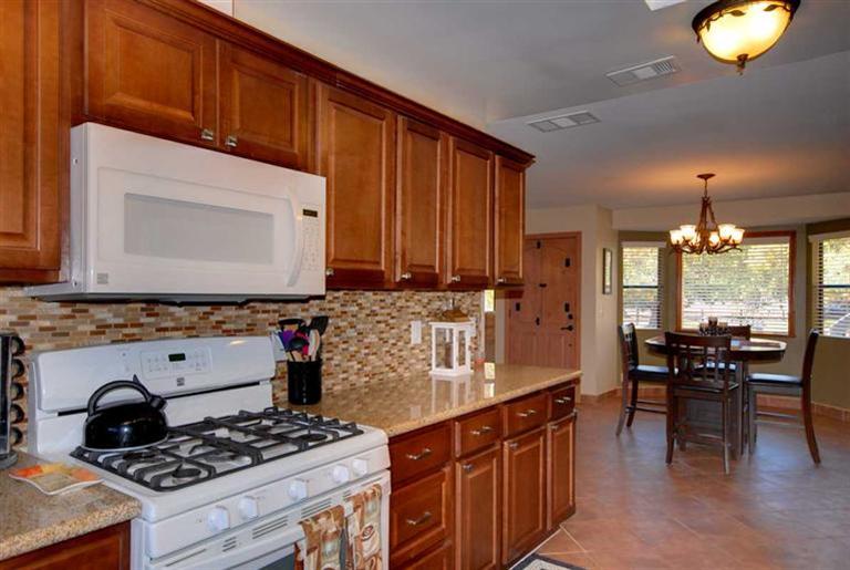198 Riverside Road Oak View, CA 93022 - Photo 6 of 24 a kitchen with stainless steel appliances granite countertop a stove a sink dishwasher and cabinets with wooden floor