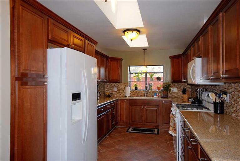 198 Riverside Road Oak View, CA 93022 - Photo 7 of 24 a kitchen with granite countertop a sink a counter top space stainless steel appliances and cabinets