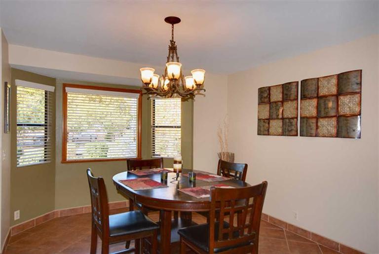 198 Riverside Road Oak View, CA 93022 - Photo 8 of 24 a view of a dining room with furniture wooden floor and chandelier