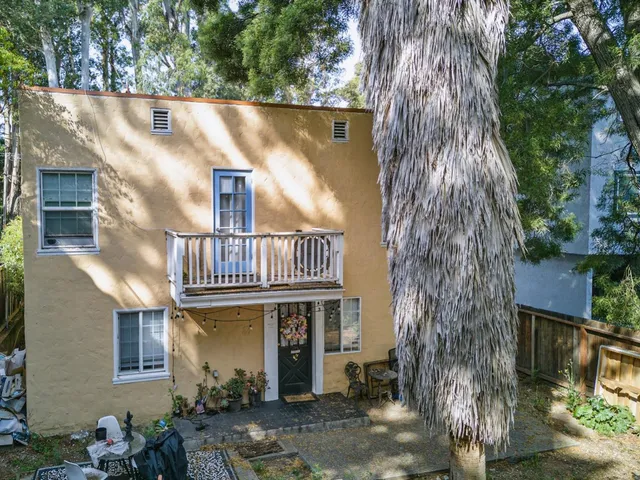 a view of a house with a tree beside it
