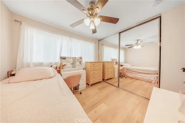a bedroom with bed and a chandelier