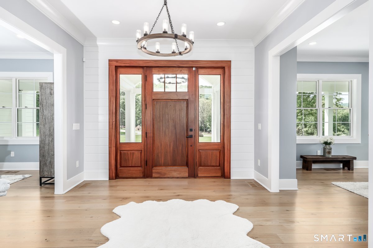 2 Pond View Lane Sherman, CT 06784 - Photo 6 of 40 a view of a livingroom with a chandelier wooden floor and windows