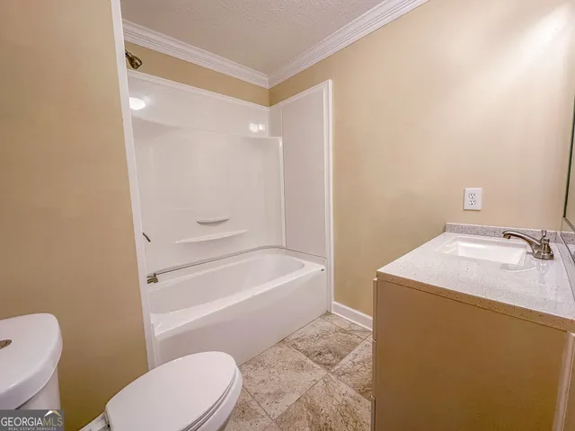 a bathroom with a sink a toilet and bathtub