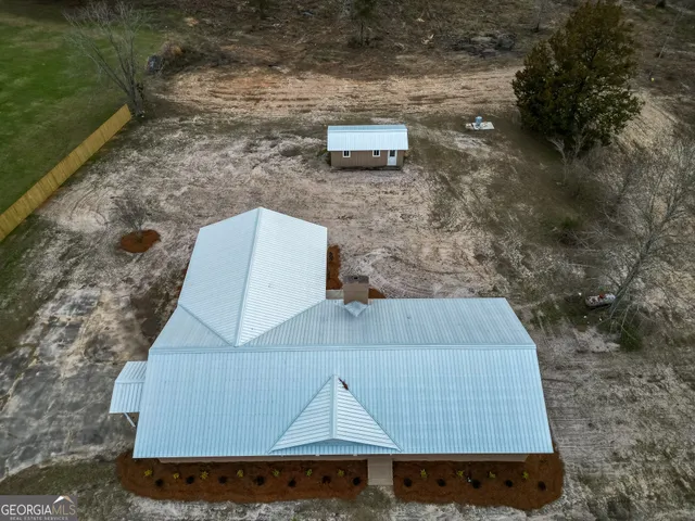 a view of a lake with a yard and large trees