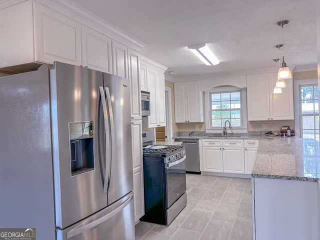 a kitchen with a refrigerator sink and stove